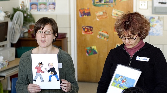 2 teacher showing pictures of people