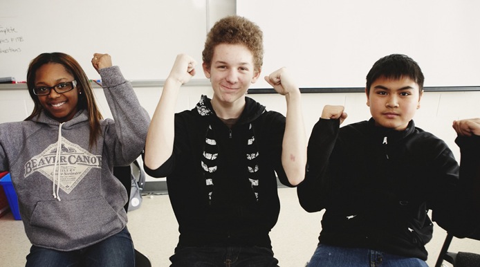 3 students showing they are strong